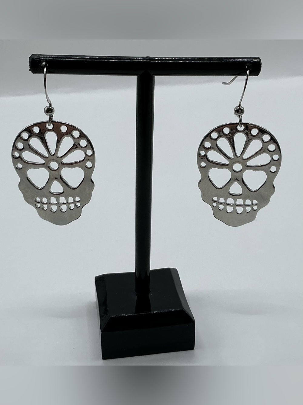 SILVER TONE CUT OUT SUGAR SKULL PIERCED EARRINGS